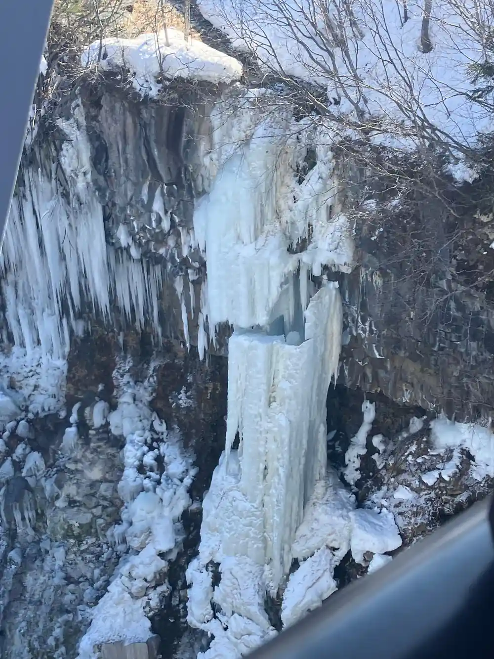 Frozen waterfall cascading over rocky cliff face