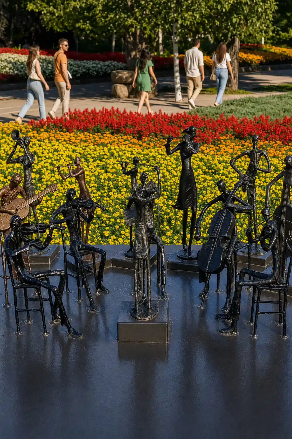 Metal musician statues with colorful flower fields